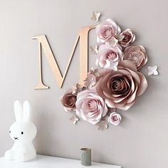 a wall clock with paper flowers on it and a bunny figurine next to it