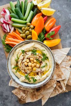 hummus with olives, peppers, carrots and other vegetables