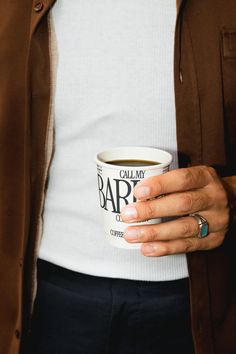 a person holding a coffee cup in their hands