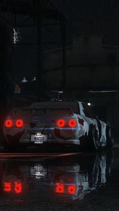 a white car with red lights in the dark