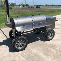 an outdoor bbq grill on wheels with the door open