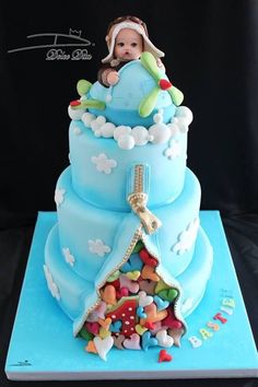 a baby is sitting on top of a blue cake