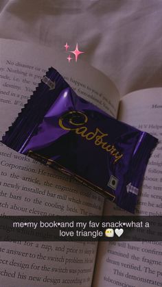 an open book with a chocolate bar on top of it and the caption reads, i meany bookrard my fav snackwh what a love triangle