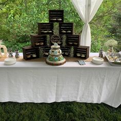 a table that has some food on top of it in front of a window with curtains