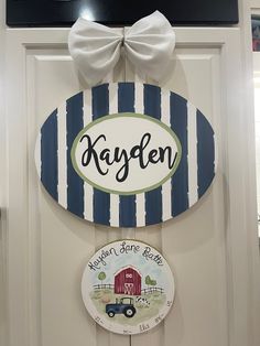 a door hanger with a sign that says, kayden next to a plate