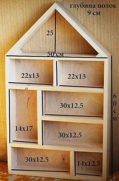 a wooden dollhouse with measurements for the top and bottom drawers on it's sides