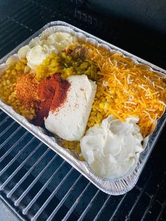 a tray filled with different types of food on top of an open oven door sill