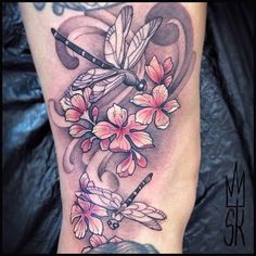 a woman's leg with flowers and dragonflies on it