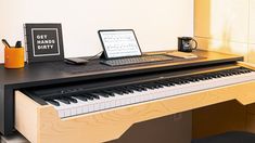 a laptop computer sitting on top of a piano keyboard