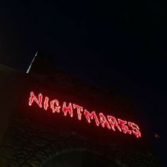 there is a neon sign that says nightmares