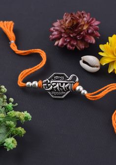 an orange string with beads and flowers on it