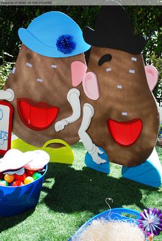 there is a large teddy bear and other items on the grass outside at a birthday party