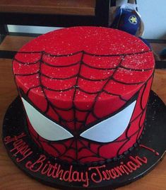 a spiderman birthday cake with sprinkles on it