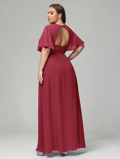 a woman in a long red dress is looking back at the camera and she has her hands on her hips