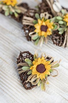 two sunflowers are placed on top of twine wreaths with burlocks