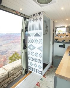 the interior of a camper with an open door