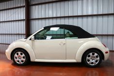 a small white car parked in a garage