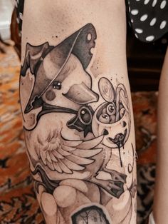 a woman's leg with an artistic tattoo design on her thigh and the image of a bird