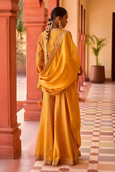 Mustard kurta featuring marodi embroidery with a round neckline and three-quarter sleeves. Paired with a coordinating sharara and dupatta., Fit: Relaxed Traditional Chanderi Sharara, Traditional Sharara With Dupatta And Traditional Drape, Traditional Chanderi Sharara With Cutdana, Banarasi Silk Palazzo Set With Dabka Work, Traditional Dola Silk Sharara For Transitional Season, Traditional Sharara With Dupatta, Traditional Palazzo Set For Navratri With Traditional Drape, Traditional Slub Silk Sharara With Dori Work, Art Silk Palazzo Set With Traditional Drape And Pallu