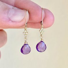 Amethyst Earrings, February Birthstone, Purple Teardrop Dangle Earrings, Minimalist Earrings Gold or Silver, Dainty Amethyst Jewelry Gift  These precious delicate earrings feature Brazilian Amethyst heart shape teardrops adorned with a white topaz connector in either gold filled or sterling silver. The purple drop earrings are suspended from lever back ear wires in the finish of your choice. These earrings are very feminine and subtle, perfect for every day. These make a perfect daily earring, o Pierced Amethyst Crystal Earrings, Purple Gemstone Teardrop Dangle Earrings, Elegant Amethyst Teardrop Dangle Earrings, Hypoallergenic Purple Dangle Teardrop Earrings, Purple Dangle Teardrop Earrings With Ear Wire, Amethyst Drop Earrings Fine Jewelry, Purple Long Drop Earrings With Ear Wire, Fine Jewelry Amethyst Drop Earrings, Amethyst Teardrop Crystal Earrings