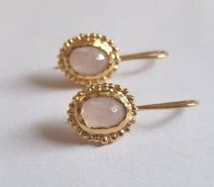 These antique inspired light pink Rose quartz earrings were 100% handmade. The pale baby pink stones are just beautiful and shine softly against the gold contour of the earring. The earrings are elegant and chic and can be great bridal earrings and lovely earrings for the summer. Dimensions: The earrings drop length is 2.5cm or 1" The oval earring size is 1.2x1 cm (0.4x0.47") The Rose quartz gems are 6X8 mm Please note that the gemstones are natural and therefore can vary from the pictures above or from one another. Materials: The earrings are available in 14k gold plating. The 14k gold earrings are also available in 9k OR 14k solid gold. These earrings are also available in other gemstones. See last couple of photo for the earrings stoned with light blue aquamarine or other stones. To see Handmade Blush Earrings As A Gift, Gold Rose Quartz Earrings For Gift, Green Amethyst Earrings, Pink Stones, Light Pink Rose, Rose Quartz Earrings, Earrings Antique, Solid Gold Earrings, Oval Earring