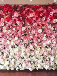 a large flower wall with many different colored flowers on it's sides and bottom