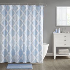 a blue and white shower curtain in a bathroom