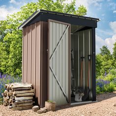 an outhouse with the door open and tools in it next to some wood logs