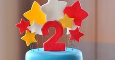 a blue cake with red, white and yellow stars on it's top that says twenty two