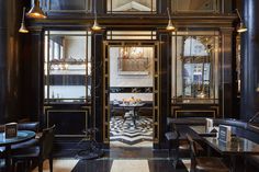 the interior of a restaurant with black and gold decor