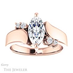 an engagement ring with a pear shaped diamond in the center and side stones on each band