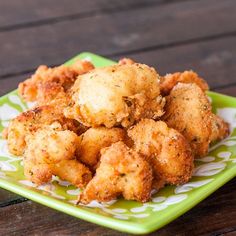 some fried food on a green and white plate