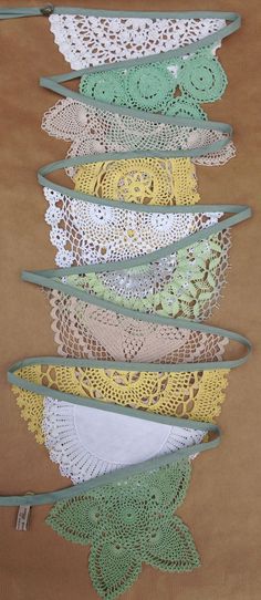 there are many crocheted doily hanging on the wall in front of each other