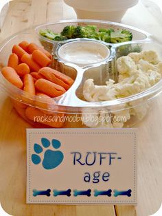 a plastic container filled with carrots, cauliflower and broccoli next to a sign that says ruff - age