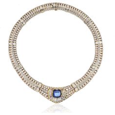 Capture the essence of elegance and luxury with our 18K Yellow Gold Approx 7.50 ct Center Cab Sapphire & Dia Necklace. This exquisite vintage piece is a testament to timeless beauty and exceptional craftsmanship. Crafted with passion in 18 karat yellow gold, it boasts a captivating center cabochon sapphire weighing 7.50 carats, radiating a mesmerizing deep blue hue.Surrounding the stunning sapphire, a meticulously arranged frame of channel-set baguette diamonds adds a touch of brilliance and sop Luxury Diamond Necklace With Jewels For Anniversary, Luxury Diamond Gemstone Necklace For Formal Occasions, Luxury Diamond Necklace With Gemstone For Formal Occasions, Luxury Sapphire Diamond Necklace, Elegant Diamond Necklace With Jewels For Formal Occasions, Elegant Diamond Necklace For Formal Occasions, Exquisite Hallmarked Diamond Necklace For Formal Occasions, Luxury Oval Diamond Necklace For Formal Occasions, Vintage Yellow Gold Diamond Necklace For Formal Occasions