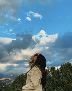 a woman is looking up into the sky