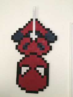 a piece of art made to look like a deadpool character hanging on a wall