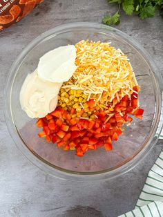 the ingredients to make this salad are in a bowl, including carrots, corn, cheese and parmesan