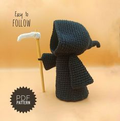 a crocheted figure holding a stick with the words easy to follow on it