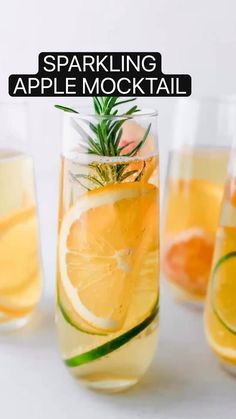 sparkling apple mocko cocktail with lemons and rosemary garnish in glassware