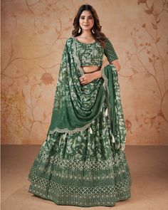 Unleash your inner royalty with our Green Faux Georgette Sequins & Zari Work Lehenga Choli in digital print With Embroidered Dupatta. The intricate zari and sequins work embroidery on lehenga, paired with a matching faux georgette blouse and matching dupatta with sequins and zari work, will have you feeling like a work of art. Elevate your style and make a statement with this luxurious piece. Lehenga Green, Georgette Lehenga, Navratri Chaniya Choli, Green Lehenga, Half Sleeve Blouse, Party Wear Lehenga, Chaniya Choli, Georgette Fabric, Sequins Embroidery