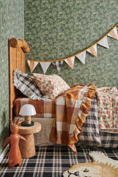 a bed room with a neatly made bed next to a night stand and table lamp