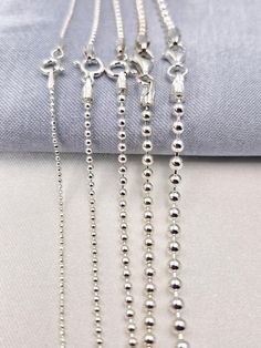 Welcome to our store! Discover the elegance of our 925 STERLING SILVER BALL BEADED CHAIN NECKLACE, a versatile and stylish piece perfect for both men and women. Whether you're looking for a choker chain for a pendant or a long chain to wear on its own, this silver ball necklace is the ideal choice. Handcrafted with care, this necklace is available in various sizes to suit your style and occasion. PRODUCT HIGHLIGHTS: PREMIUM QUALITY: Made from genuine 925 sterling silver, this ball beaded chain i Silver Ball Chain Necklace As A Gift, Silver Necklace With Ball Chain As Gift, Silver Necklace With Ball Chain For Gift, Sterling Silver White Gold Ball Chain Jewelry, Sterling Silver Jewelry With Ball Chain In White Gold, Sterling Silver Jewelry With White Gold Ball Chain, White Gold Ball Chain Necklace As Gift, Silver Chain Necklace With Lobster Clasp And Round Beads, Silver Beaded Sterling Silver Chain Necklace