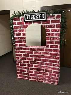 a red brick wall with a sign that says tickets