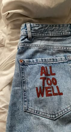 the back pocket of a pair of jeans with an all too well sticker on it