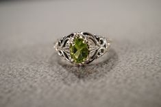 I am offering you this vintage sterling silver, wedding band stacker design ring. It features an oval shaped prong set genuine peridot. stones This stone is set in a scrolled single stone setting. There is fabulous raised relief design work here. It is measuring app. 3/4 inch, by app. 1/2 inch. It is currently a size 8 , though I am sure it could be sized up or down. It weighs app. 5 grams.  Look at the detail of the design work of this vintage ring Simply breathtaking. This ring came out of an Classic Peridot Birthstone Ring, Oval Peridot Birthstone Ring For Anniversary, Vintage Peridot Rings For Wedding, Formal Oval Peridot Birthstone Ring, Vintage Peridot Ring For May Birthstone, Oval Peridot Jewelry For Wedding, Oval Peridot Wedding Ring, Oval Peridot Heirloom Jewelry, Heirloom Oval Peridot Jewelry