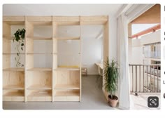 an empty room with wooden shelves and potted plants