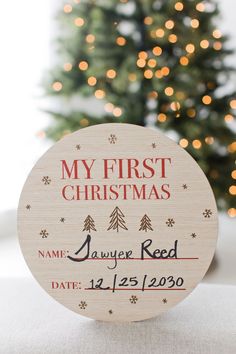 a wooden christmas ornament with the words, my first christmas name and date