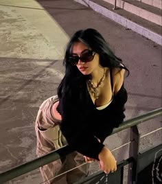 a woman standing on top of a metal rail