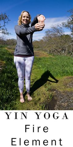 a woman standing in the grass with her hands up and text that reads yin yoga fire element